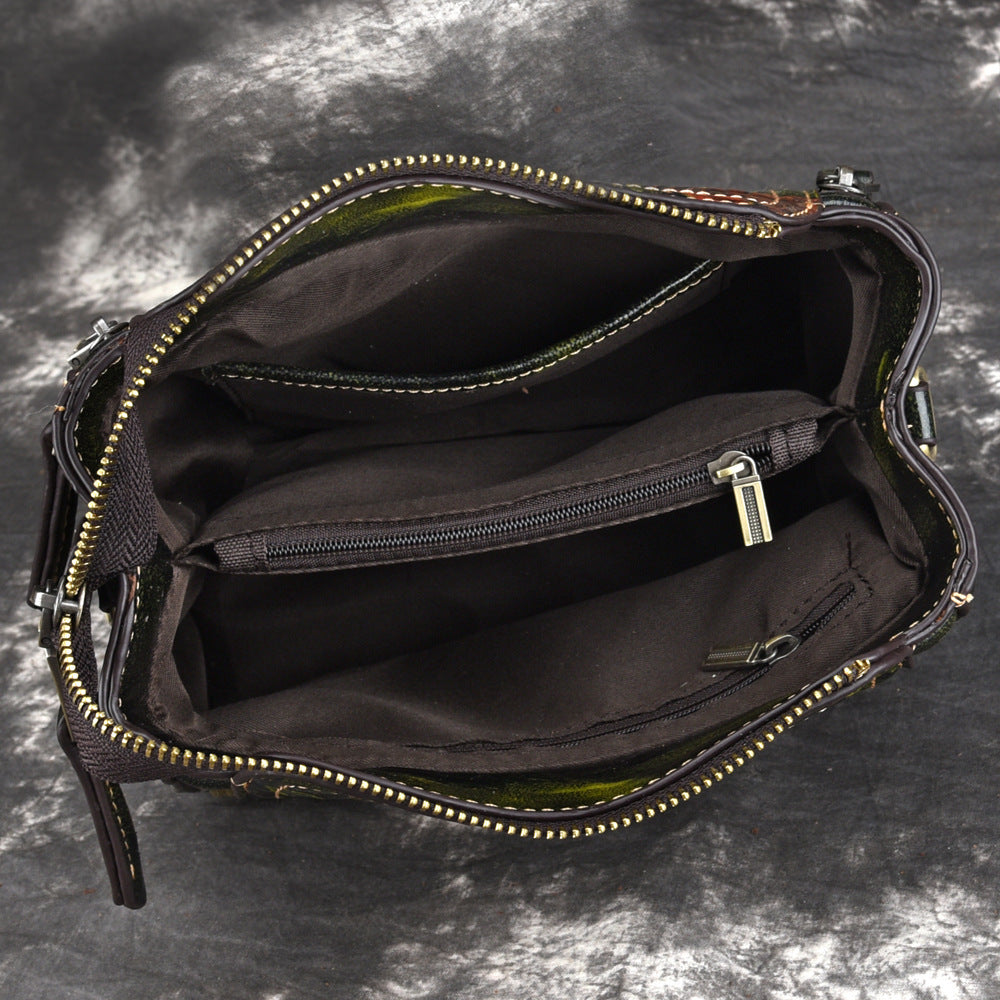 Open American designer leather handbag shoulder bag for women showing interior compartments and zipper pockets