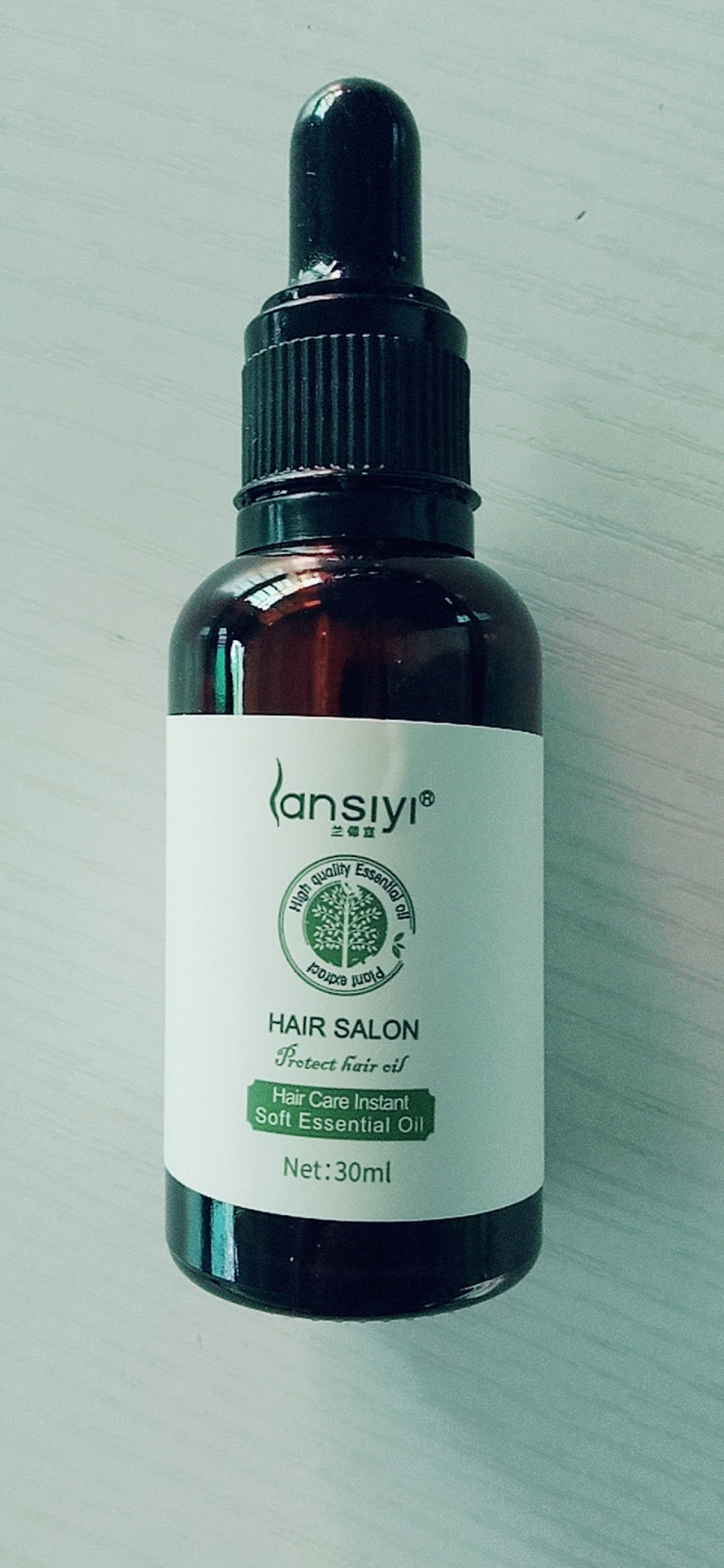 Yiwu Renfan hair care essential oil in a 30ml dark glass dropper bottle for hair salon use