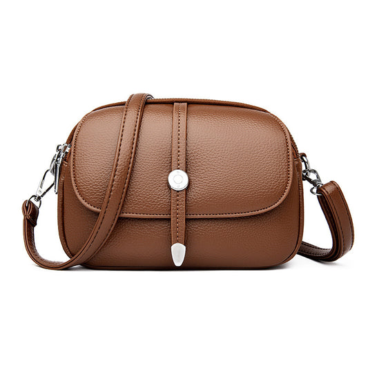 Brown leather city crossbody bag for women with adjustable strap and silver button closure