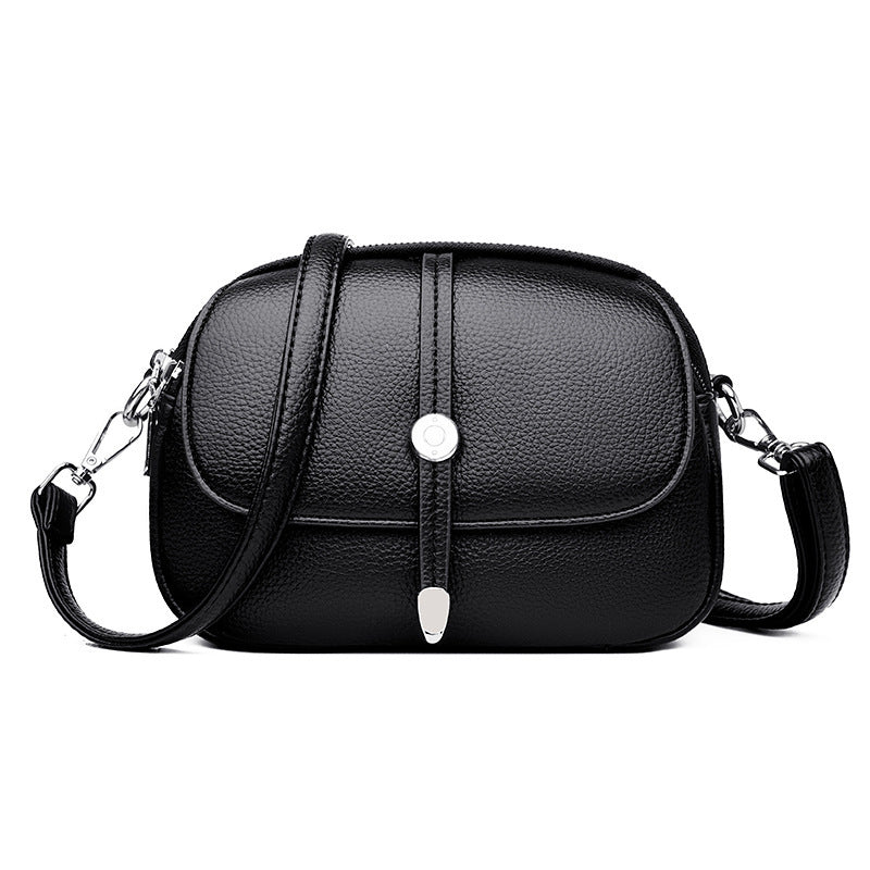 Black leather city crossbody bag for women with adjustable strap and silver button detail