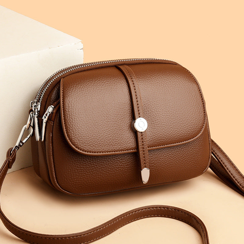 Brown leather city crossbody bag for women with adjustable strap and silver zipper details