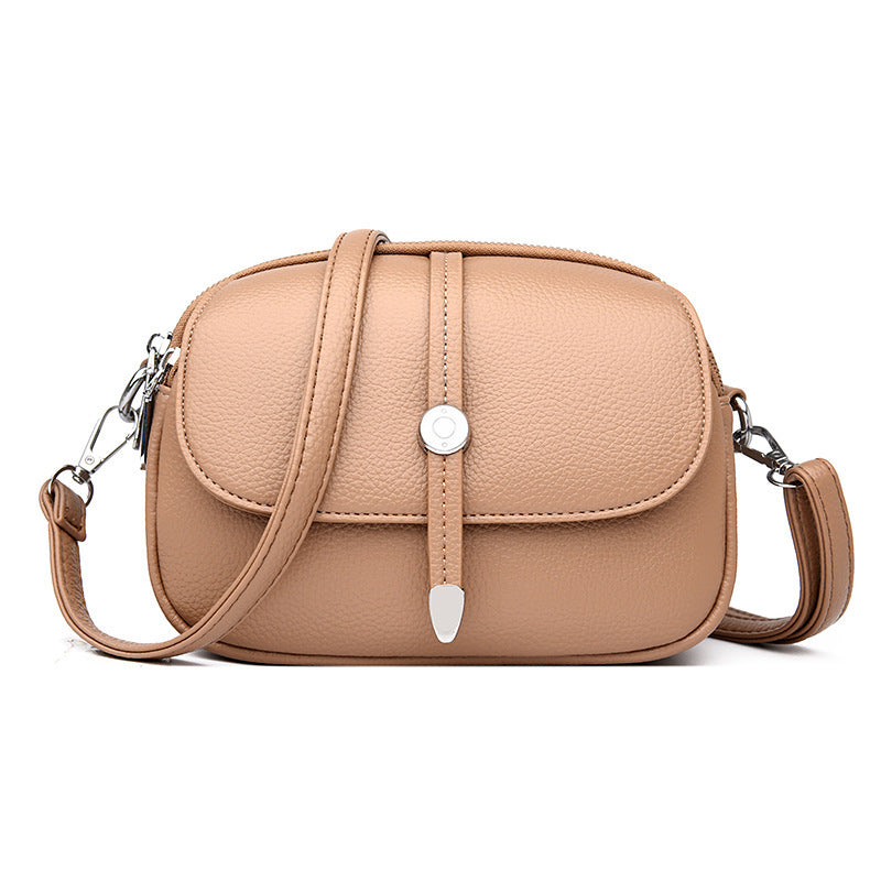 Beige city crossbody bag for women with adjustable strap and silver buckle closure
