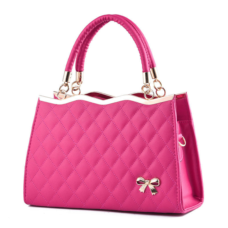 Pink crossbody bag with bow detail and quilted pattern by Yiwu Renfan