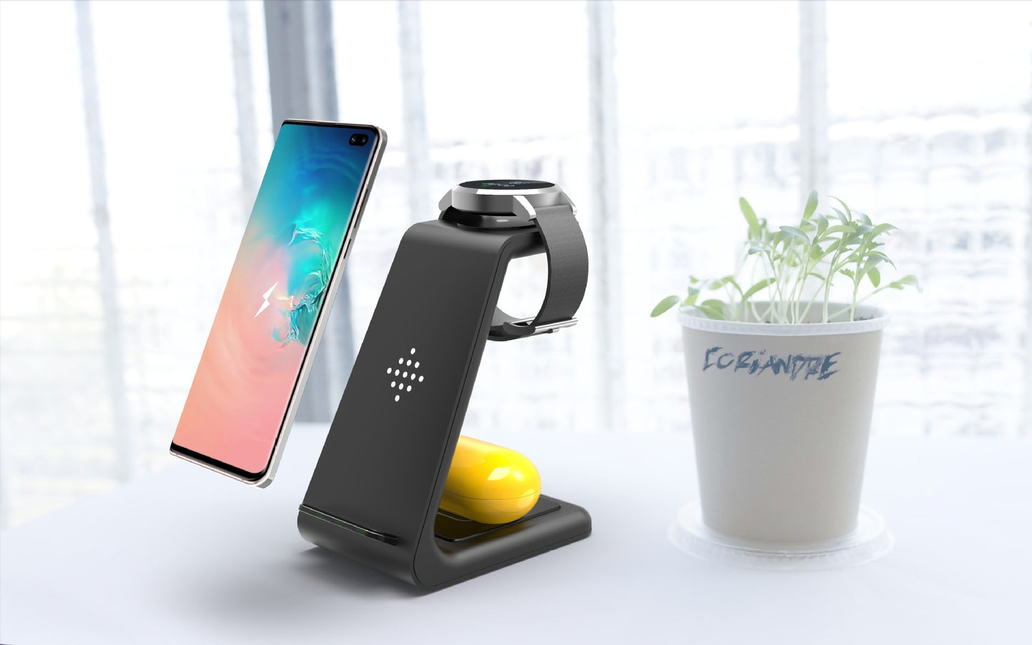 3 in 1 wireless charging station by Hangzhou Jingqian with a smartphone, smartwatch, and wireless earbuds
