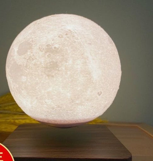 Box of Pandora magnetic levitation moon lamp floating above wooden base glowing softly