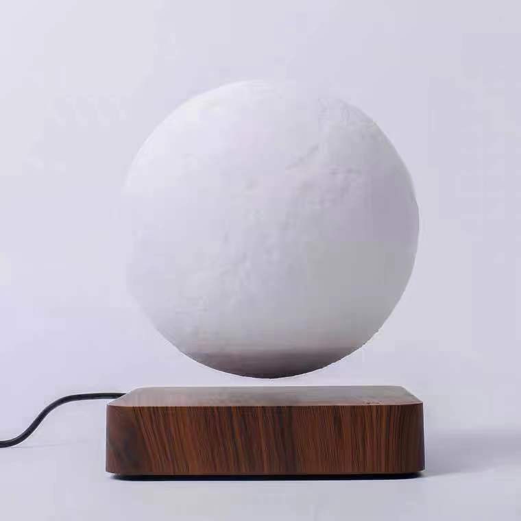 Magnetic levitation moon lamp floating above wooden base with power cord from Box of Pandora