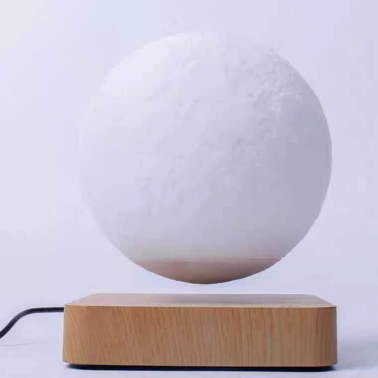 Box of Pandora magnetic levitation moon lamp floating above wooden base with power cable