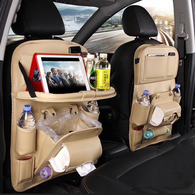 Beige multifunction car seat tray organizer hanging on car seat back with tablet, bottles, and storage compartments