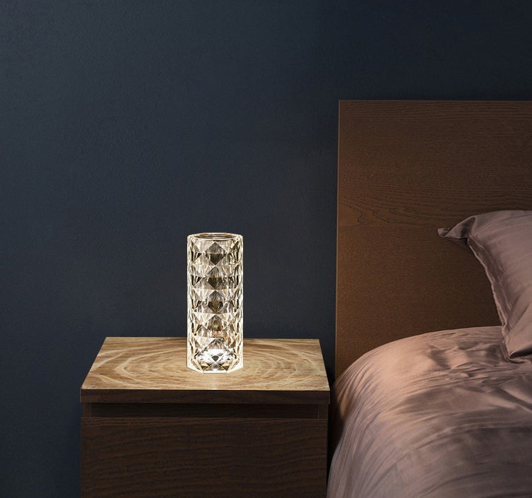 Nordic crystal lamp for bedroom on wooden nightstand next to bed illuminating dark room