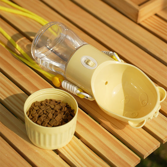 Yellow portable dog water bottle with attached bowl and separate container of dog food on wooden surface