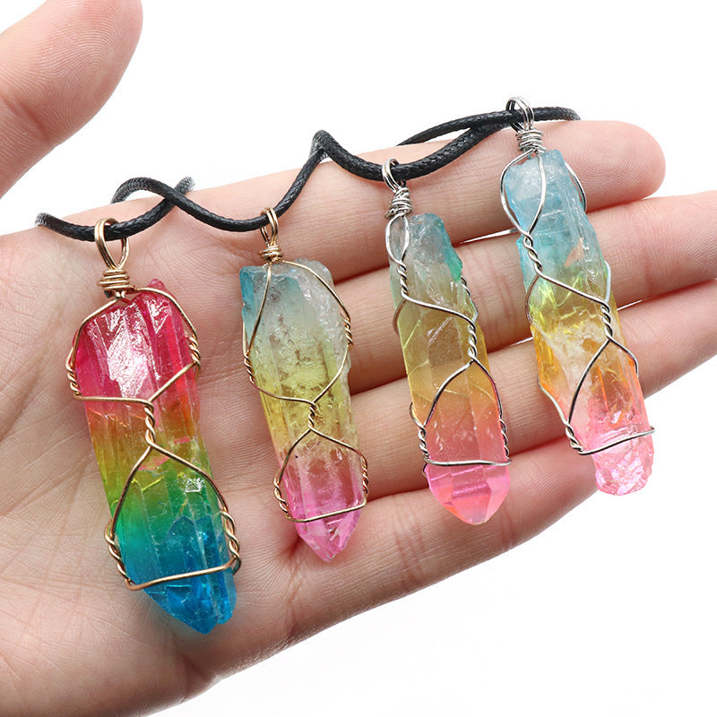 Hand holding four rainbow stone jewelry for wellness pendants with wire wrapping on black cords