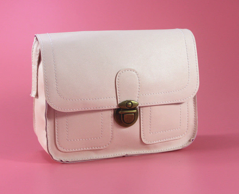 Stylish pink retro buckle shoulder bag with a secure clasp and front pockets