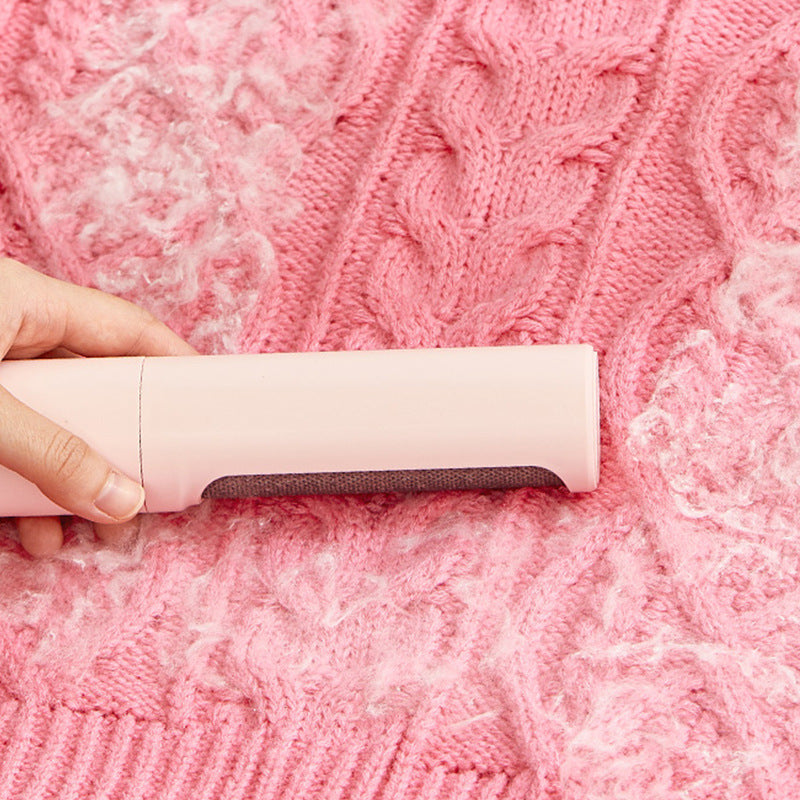 Hangzhou Jingqian reusable pet hair remover brush cleaning white pet hair from a pink knitted sweater
