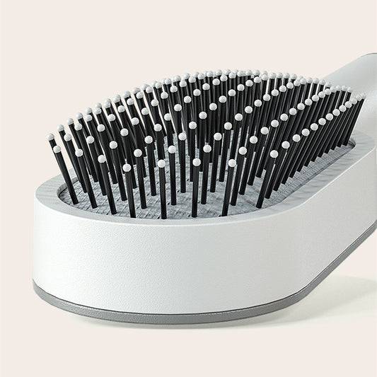Yiwu Renfan self cleaning hair brush with black bristles and white rounded tips for hair loss massage