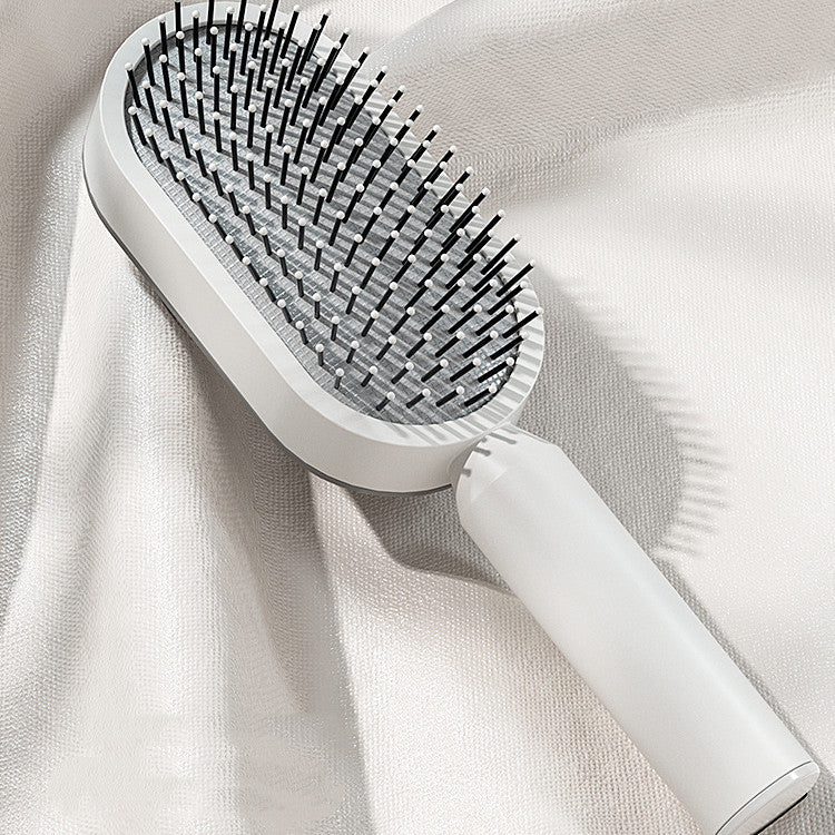 Yiwu Renfan self cleaning hair brush with airbag massage and black bristles on white handle