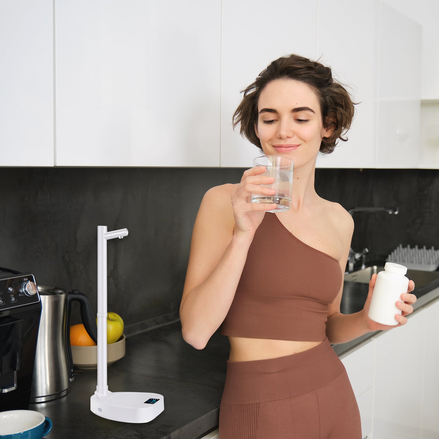 Desktop rechargeable touch control water dispenser by Hangzhou Jingqian on kitchen counter with woman drinking water