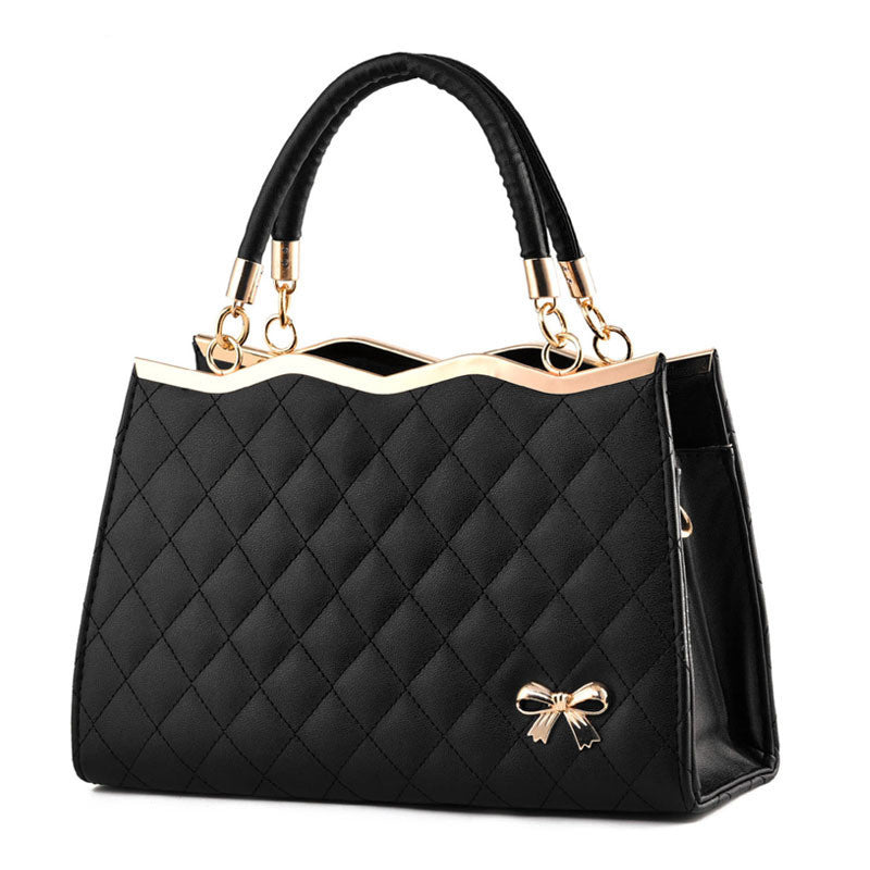 quilted black handbags for women featuring a structured top handle bag with gold trim bow accent and spacious interior