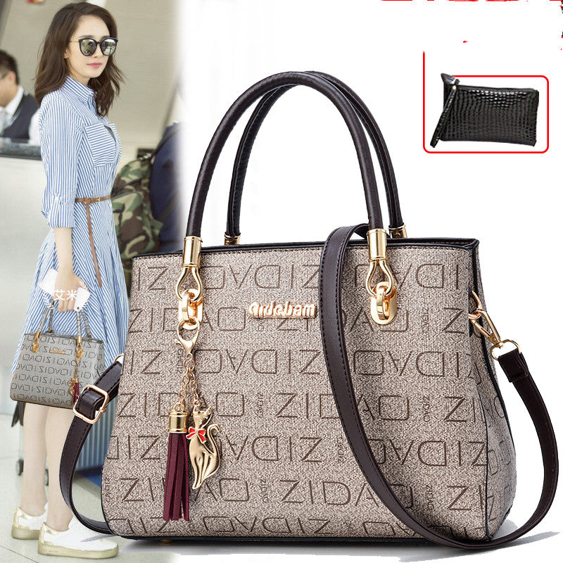 Designer handbag with brand name and decorative elements, featuring a woman in the background.