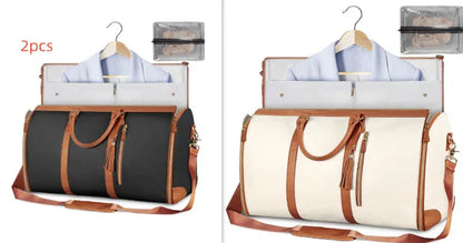 Two stylish travel garment bags with leather straps, one black and one white, each holding a hanger with clothes