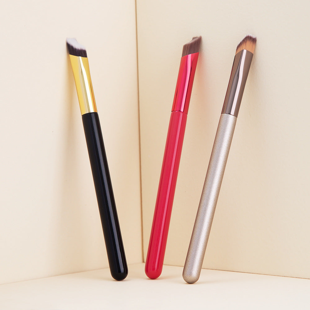 Three 3D eyebrow brush for women in black, red, and silver handles with angled bristles