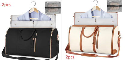 Two travel garment bags in black and cream with brown accents, displayed with jackets and matching accessories