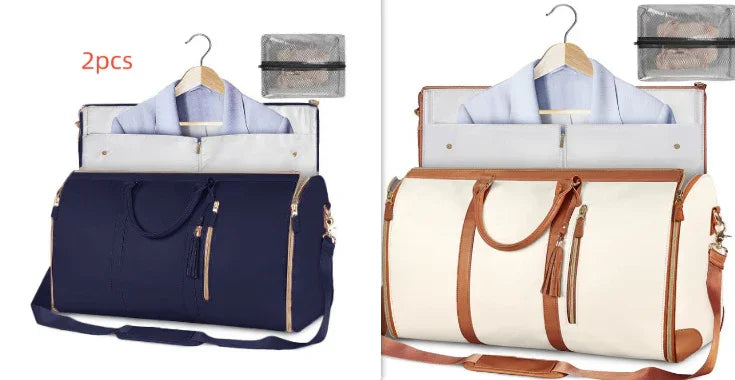 Two garment travel bags in navy blue and cream with brown handles, each holding a hanging suit jacket and packing cubes