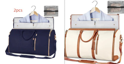 Two garment travel bags in navy blue and cream with brown handles, each holding a hanging suit jacket and packing cubes