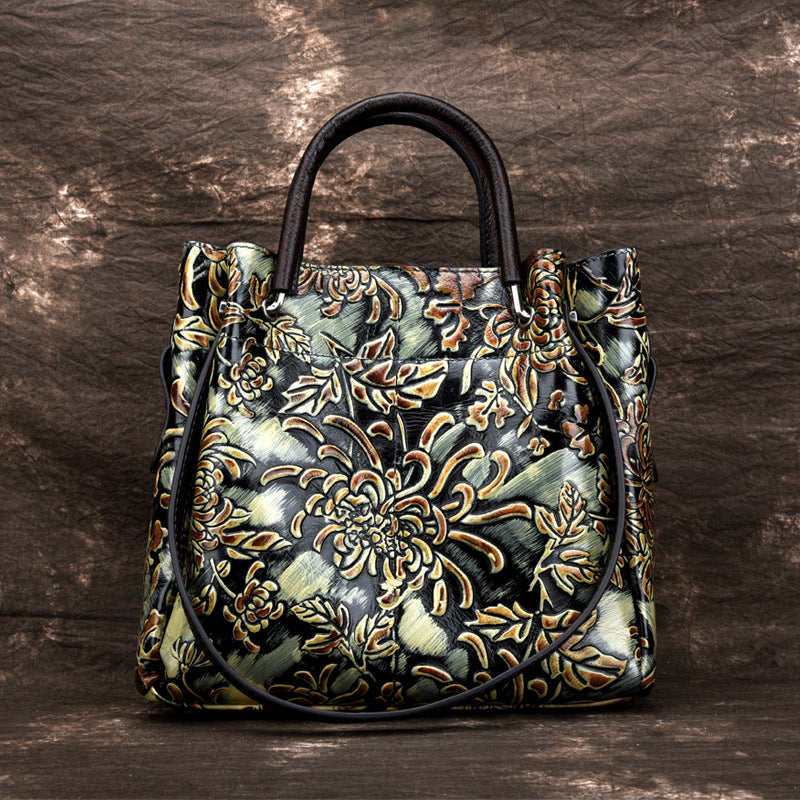 Handbag with intricate floral patterns on a wooden surface