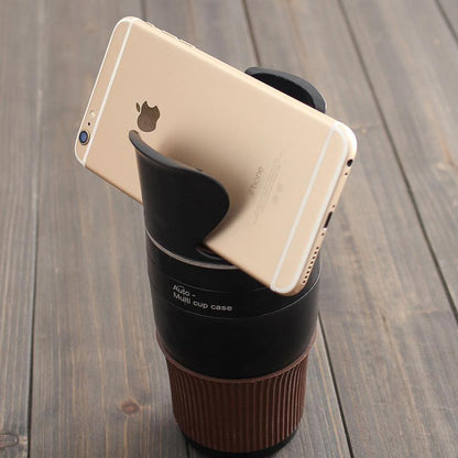 Adjustable car drink holder by Hangzhou Jingqian holding a travel cup and a smartphone