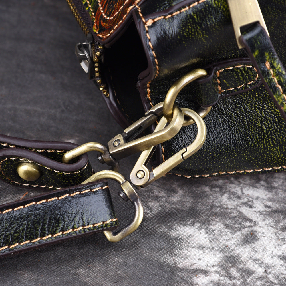 Close-up view of American designer leather handbag strap and metal clasps on black shoulder bag