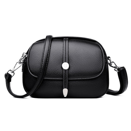 Black leather city crossbody bag for women with adjustable strap and silver button detail