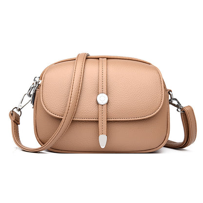 Beige city crossbody bag for women with adjustable strap and silver buckle closure