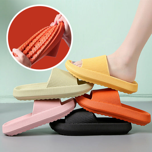 Colorful couple slippers stacked with a foot wearing yellow slip-on for comfortable indoor house slides