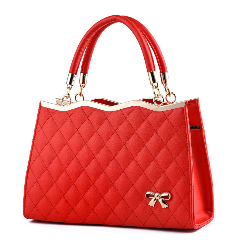 Red quilted crossbody bag with bow detail and dual handles from Yiwu Renfan