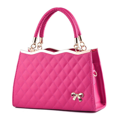 Pink crossbody bag with bow detail and quilted pattern by Yiwu Renfan
