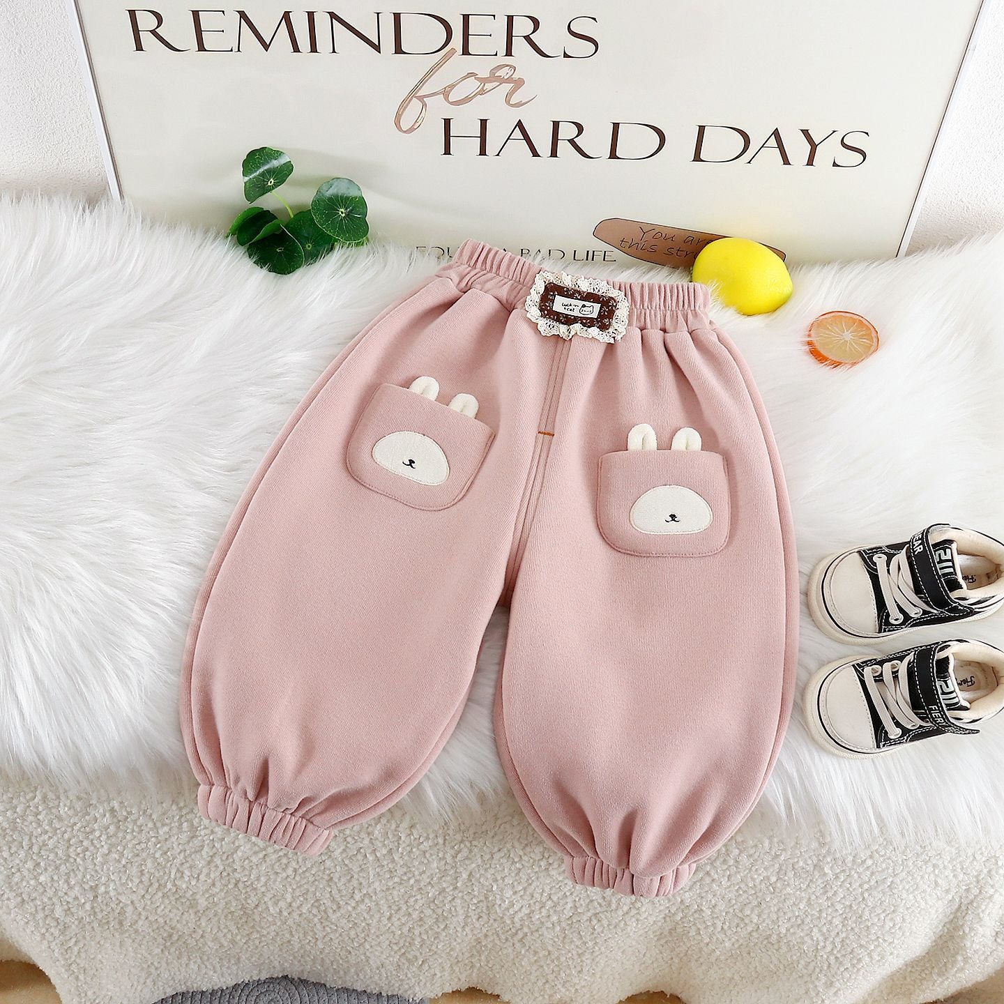 Cute warm trousers for girls featuring bunny pockets and a soft pink fabric