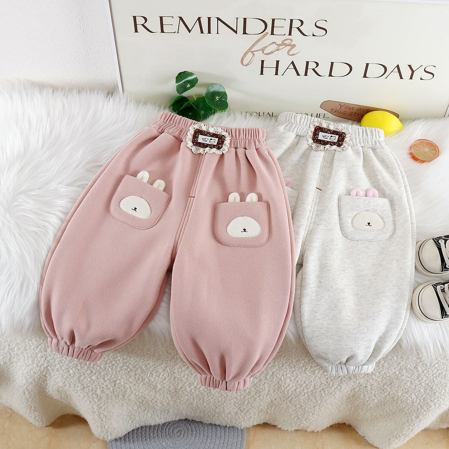 Cute warm trousers for girls in pink and gray with bunny pocket details and an elastic waistband