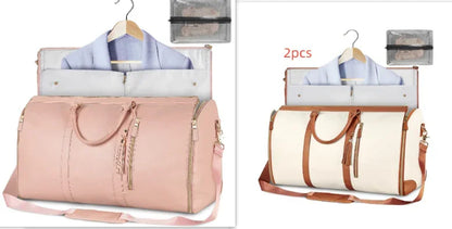 Two large travel garment bags in pink and white with brown straps, shown open with clothes inside