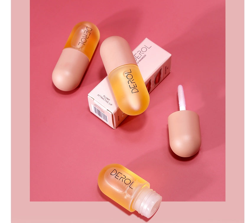 Yiwu Renfan Night instant lip plumper oil in capsule-shaped containers with applicator on pink background