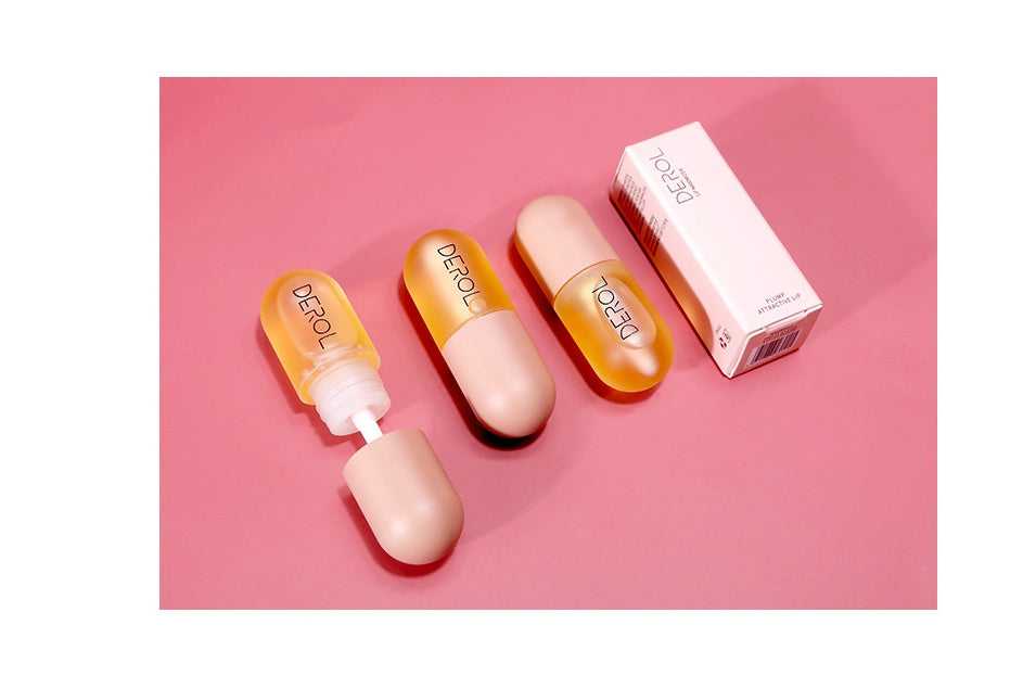 Yiwu Renfan Night Instant Lip Plumper Oil clear bottles with beige caps and packaging on pink background