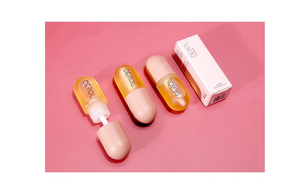 Yiwu Renfan Night Instant Lip Plumper Oil clear bottles with beige caps and packaging on pink background