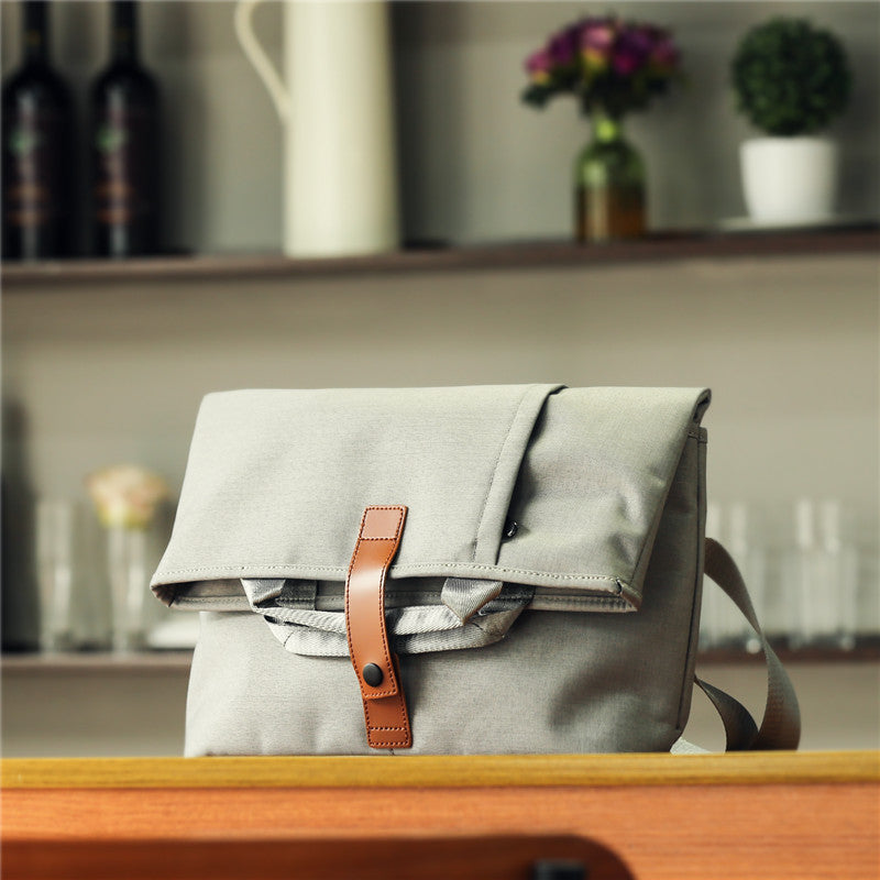 Stylish and durable messenger bags for men in gray with a leather strap and practical design