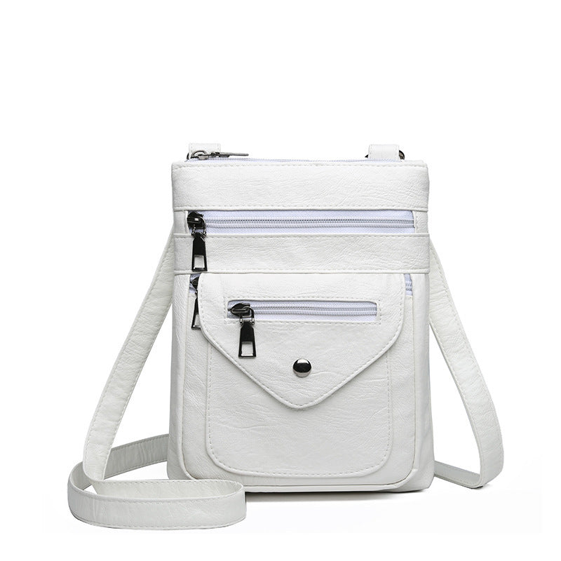 White lightweight crossbody bag for women with multiple zippered pockets and adjustable strap