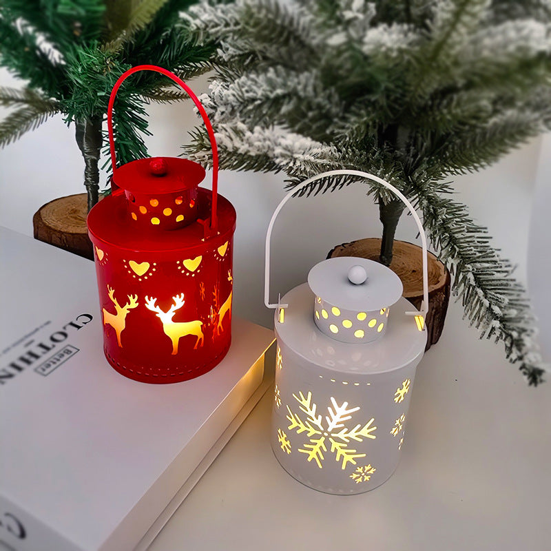 Two LED Christmas candle lanterns in red and white with festive cutouts, perfect for holiday decor