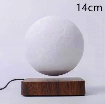 Box of Pandora magnetic levitation moon lamp floating above wooden base with power cord