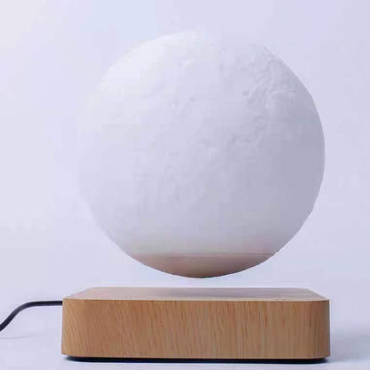 Box of Pandora magnetic levitation moon lamp floating above wooden base with power cable