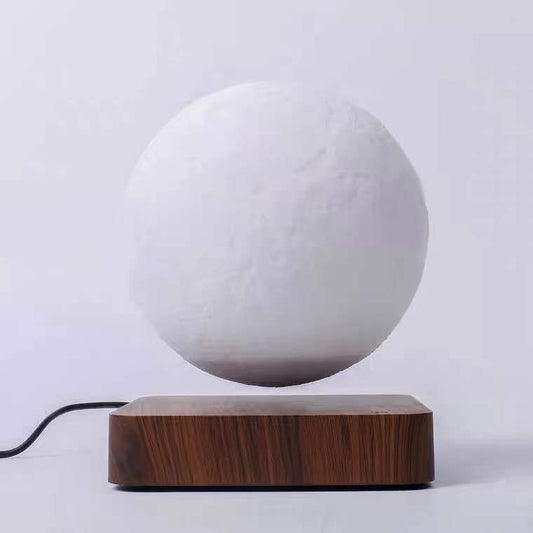 Magnetic levitation moon lamp floating above wooden base with power cord by Box of Pandora