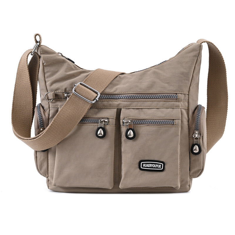 Box of Pandora multi pocket crossbody bag for women in beige with adjustable strap and zippered pockets