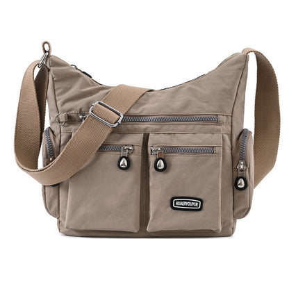 Box of Pandora multi pocket crossbody bag for women in beige with adjustable strap and zippered pockets