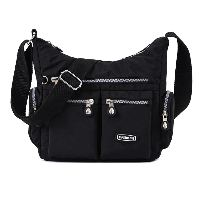Black multi pocket crossbody bag for women with multiple zippered compartments and adjustable strap